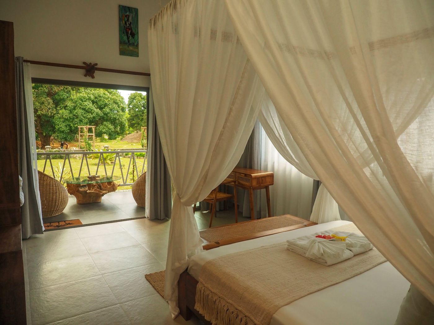 Bed under a mosquito net at a Kokoa Serena villa