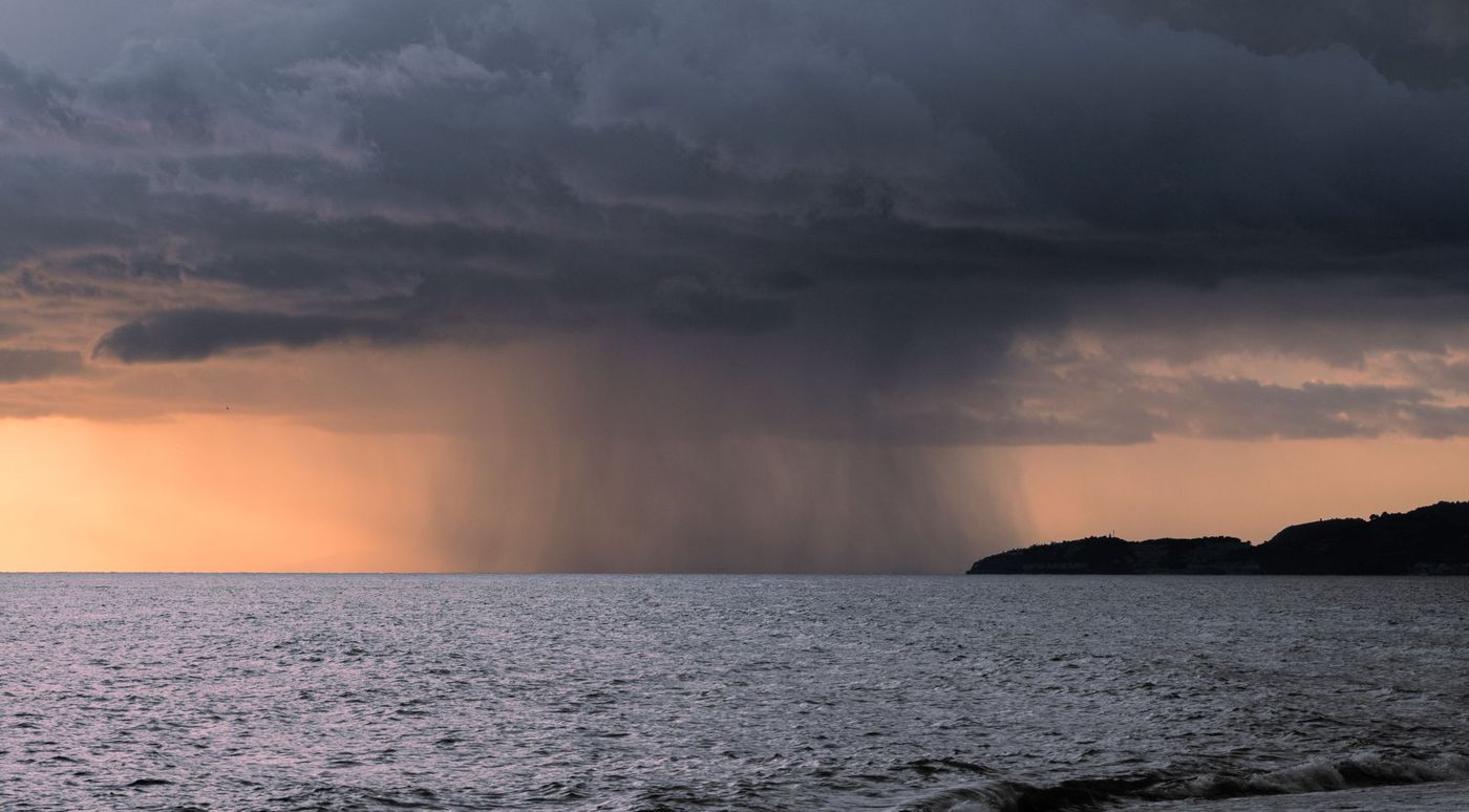 Rain squall over the sea at dusk